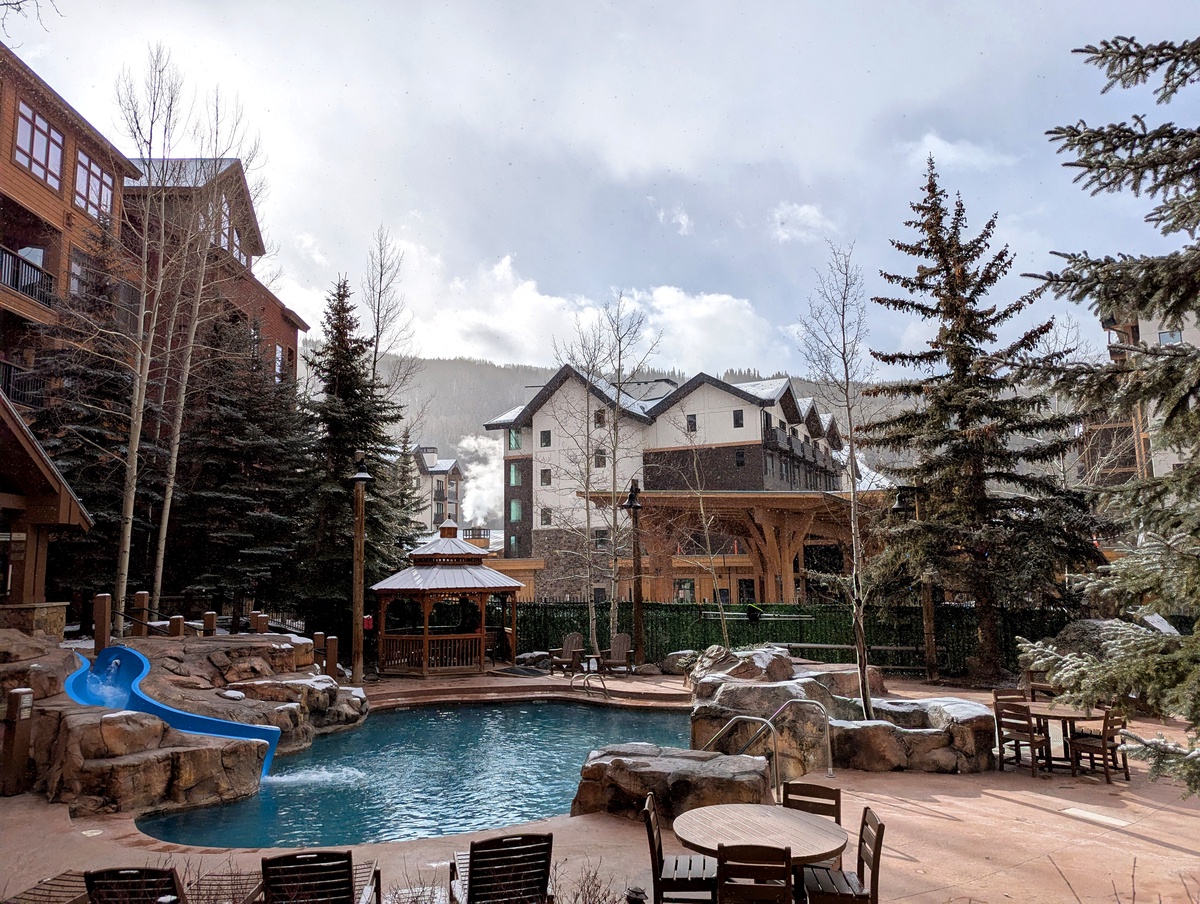 This patio is perfect, poolside with views and easy access to the shared grilling area