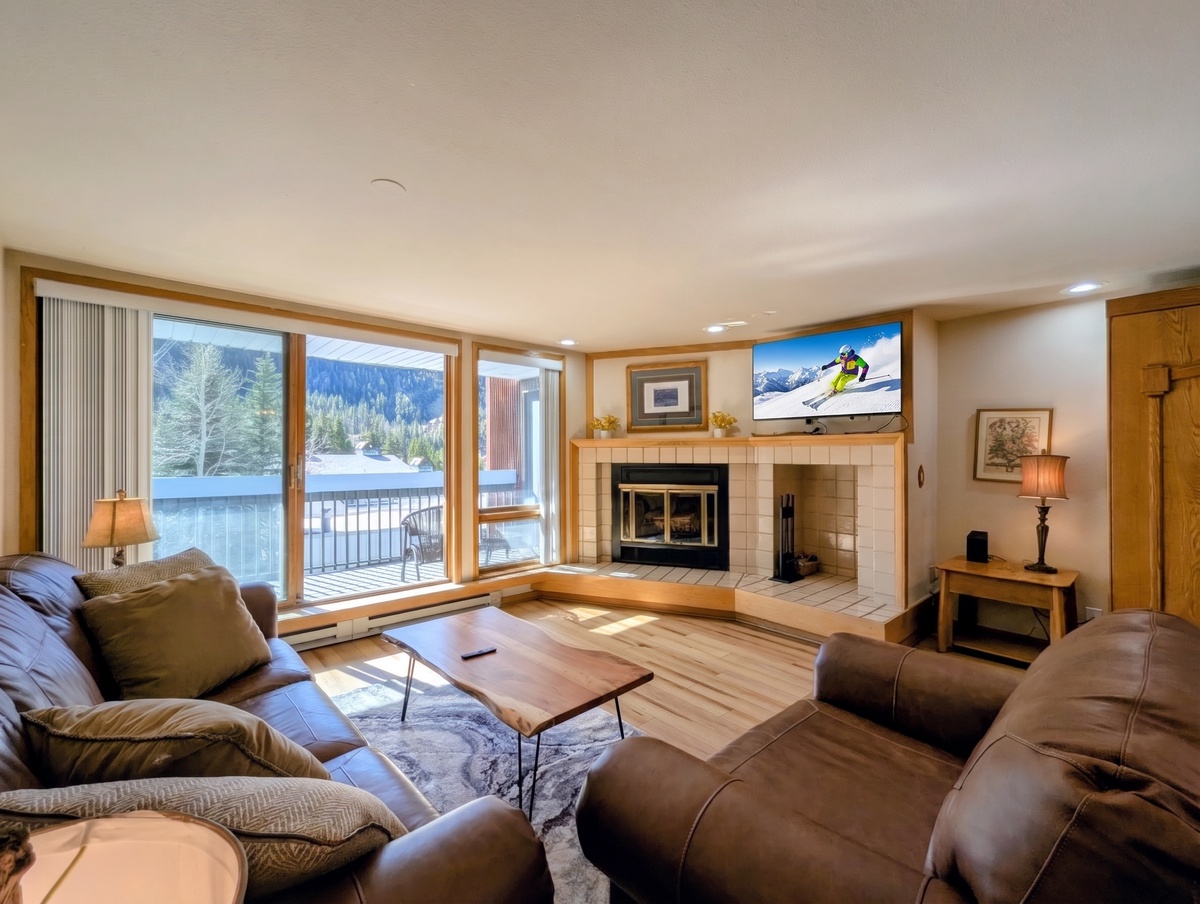 Unwind in your cozy living space where mountain views frame your getaway. Curl up by the fireplace or step onto your private balcony overlooking the snowy landscape.