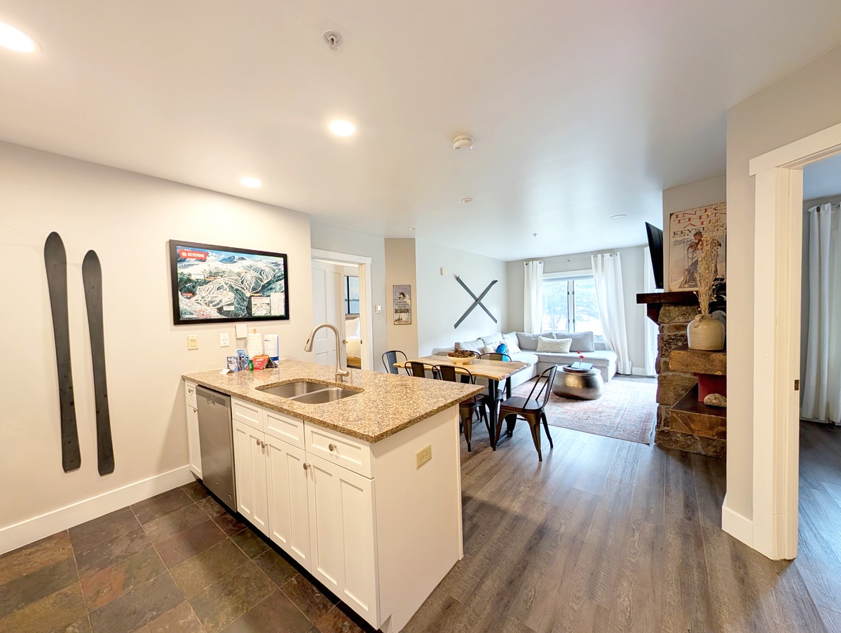 Your modern mountain retreat features a chef's kitchen flowing into a cozy living space with dining area and fireplace