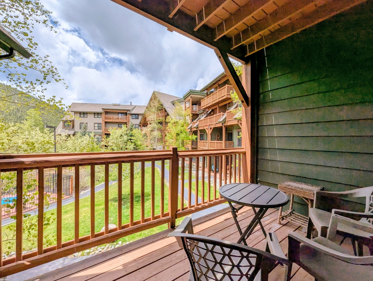 Step onto your private balcony and breathe in the fresh mountain air. Enjoy morning coffee surrounded by trees and neighboring lodge charm—a peaceful retreat awaits.