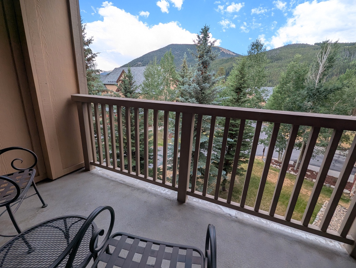 Step out onto your private balcony and take in the sweeping mountain views framed by evergreens and blue skies, perfect for morning coffee or evening relaxation.