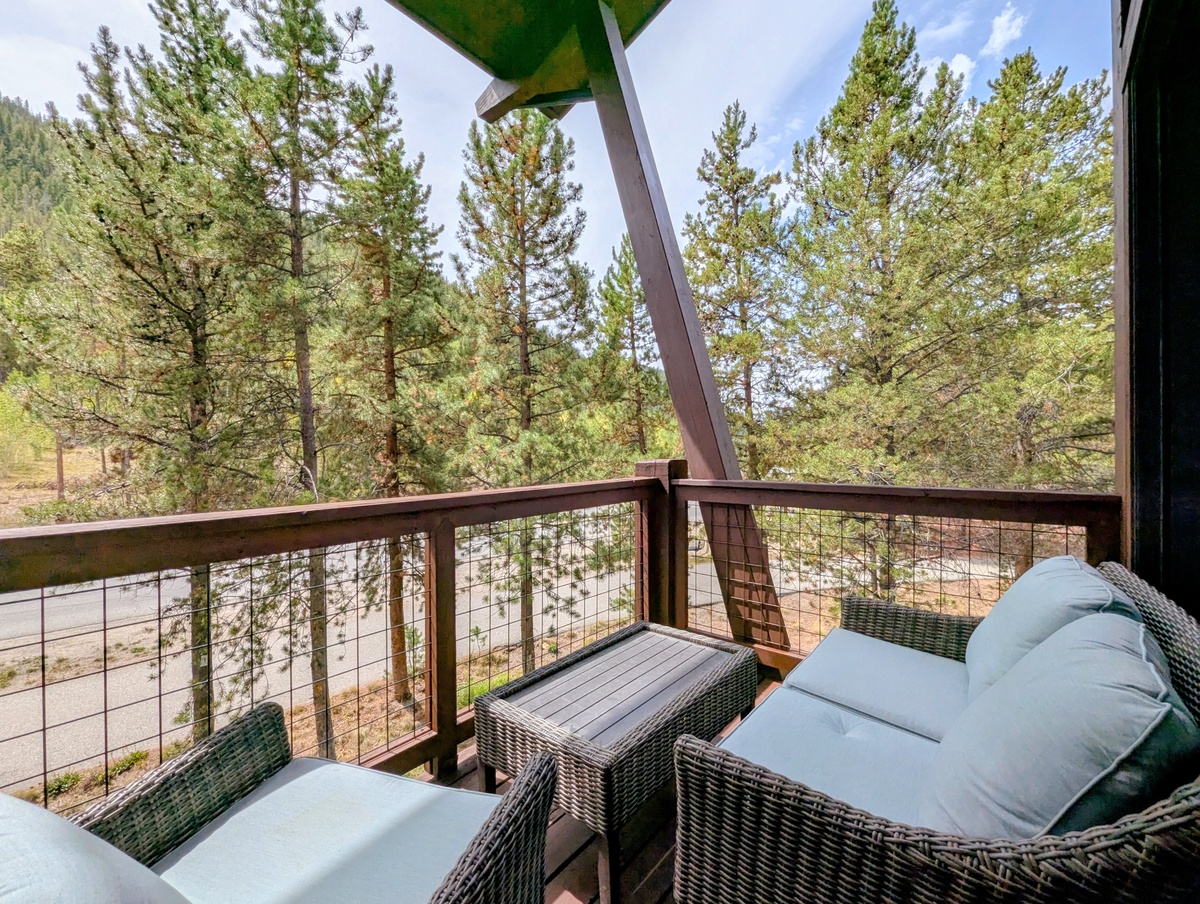 Settle into your private balcony and soak up sweeping views of towering pines and peaceful woodland—perfect for morning coffee or unwinding as the breeze rustles through the trees.
