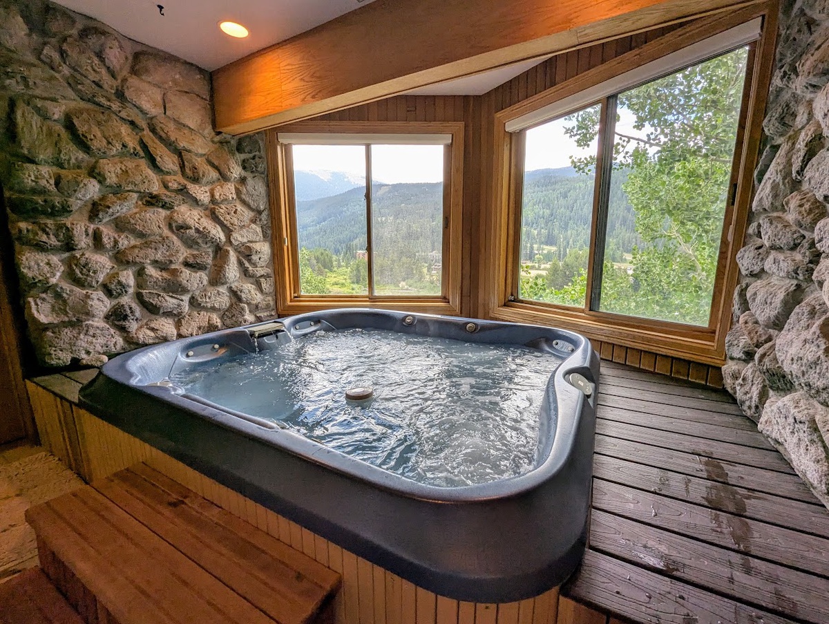 Private indoor hot tub with mountain views