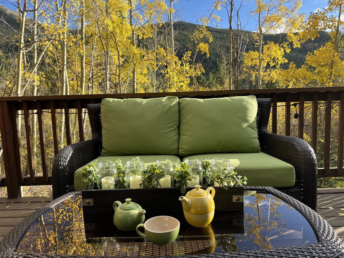 Sip your morning tea on this peaceful deck surrounded by golden aspens and mountain views—a perfect retreat for unwinding in nature's beauty.