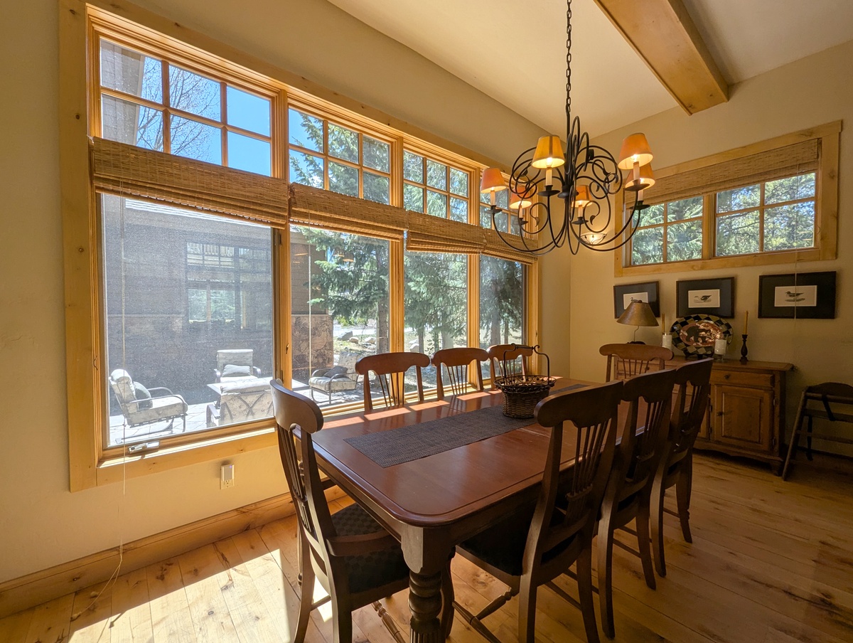 Gather around this beautiful dining table where sunlight streams through expansive windows, creating the perfect backdrop for your memorable meals together.