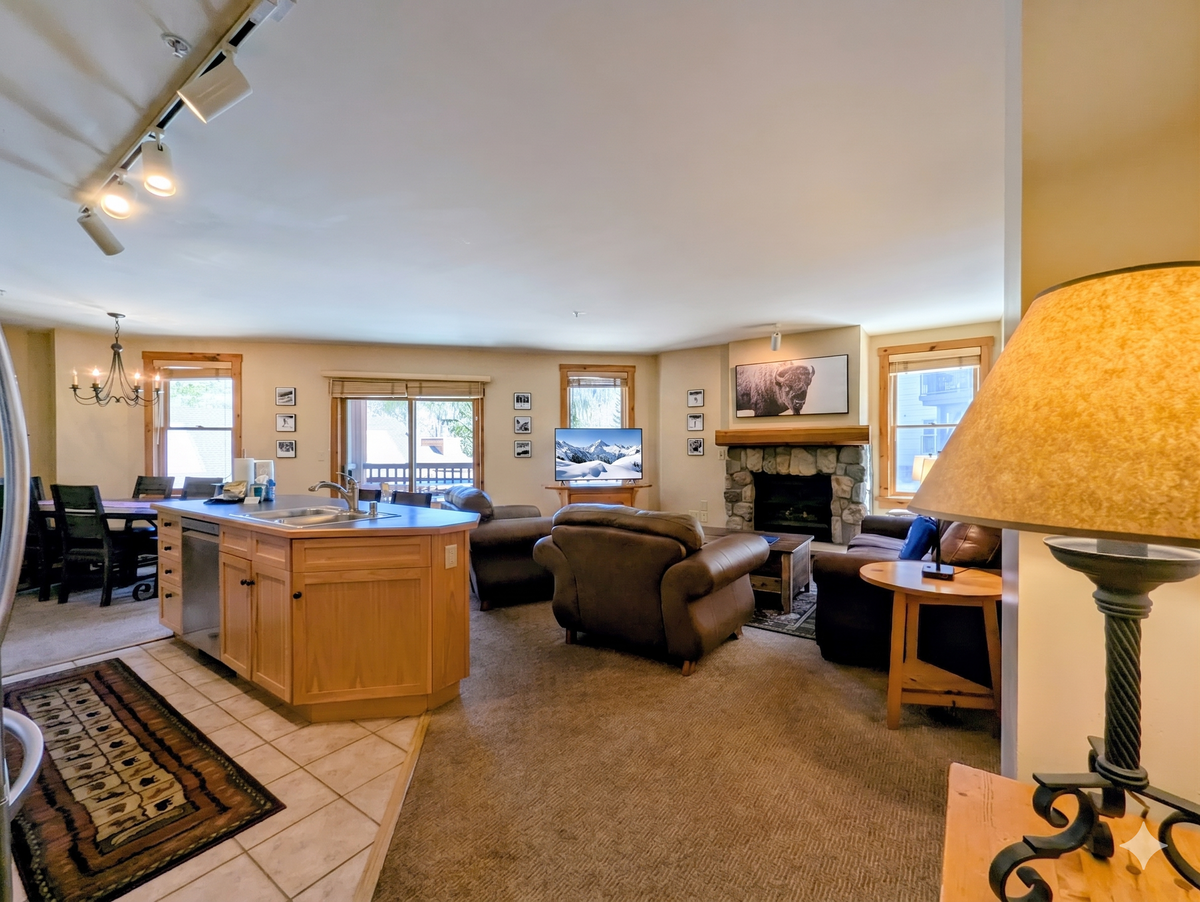 Sink into comfortable leather sofas by the stone fireplace or gather at the spacious kitchen island—your perfect home base for mountain getaways and shared meals.