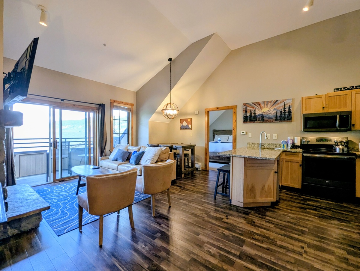 Bright, open retreat with soaring vaulted ceilings and warm wood tones. Relax in the living area or cook in the full kitchen, all bathed in natural light from large windows.