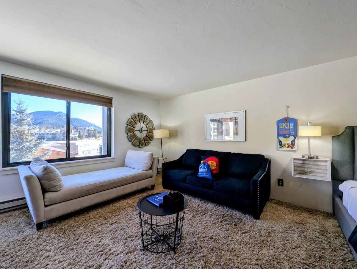 Unwind in your stylish living space with plush seating and stunning mountain views framing your winter getaway.
