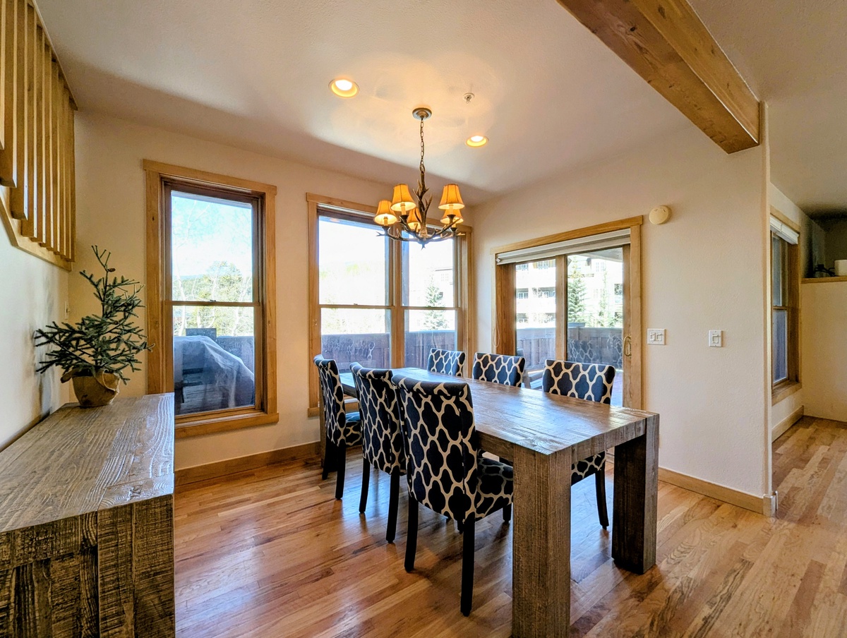 Gather around your elegant dining table where rustic wood beams meet modern style, creating the perfect space for memorable meals together.