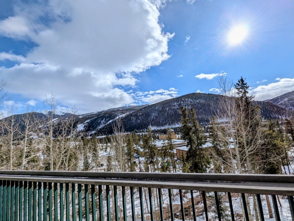 Stunning winter mountain views stretch across snow-covered peaks and valleys from this peaceful balcony retreat.