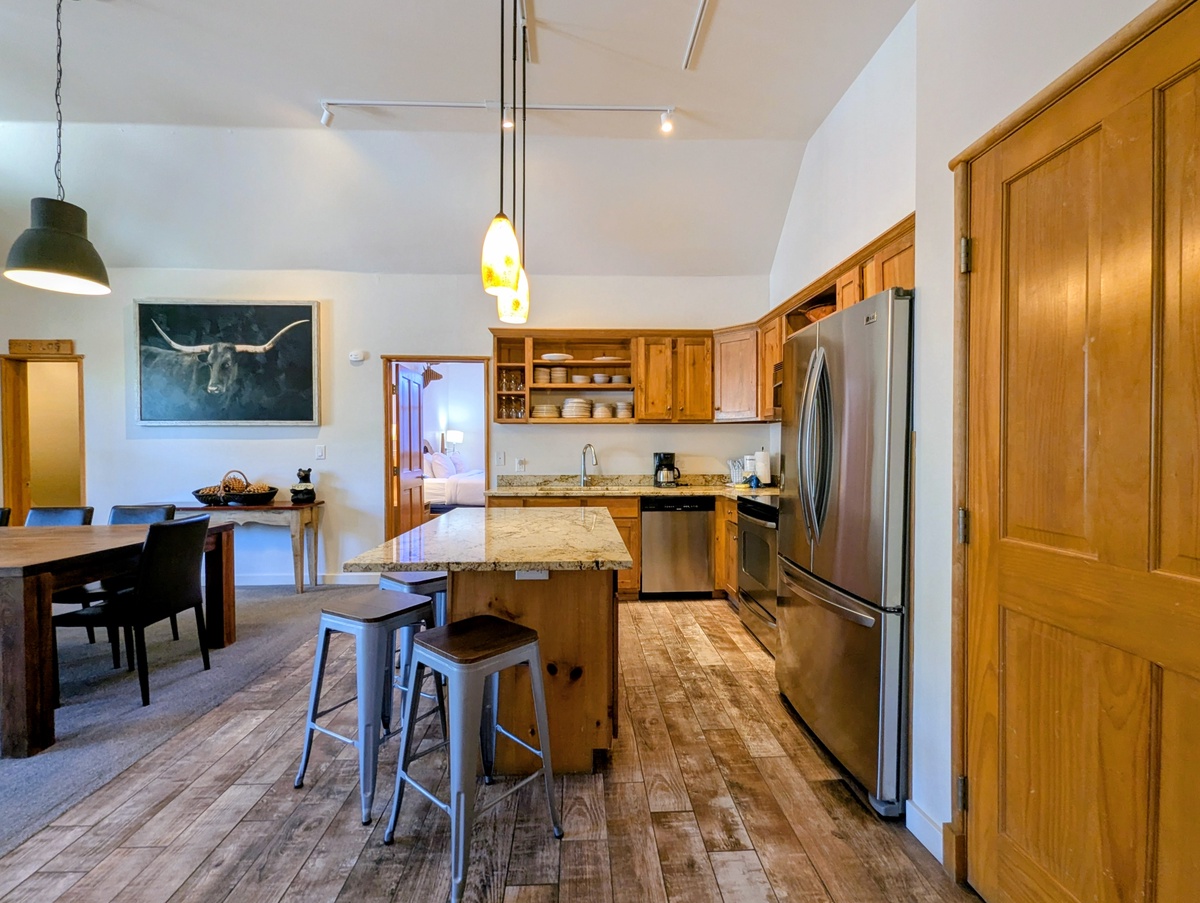 Your spacious kitchen features granite counters, stainless appliances, and a breakfast island where you can gather for morning coffee or prep meals together in this open space.