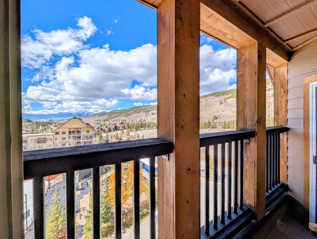 Stunning mountain views frame the landscape from this private balcony, where blue skies and alpine peaks create a serene backdrop. Step outside and breathe in the fresh mountain air as you take in the sweeping scenery.