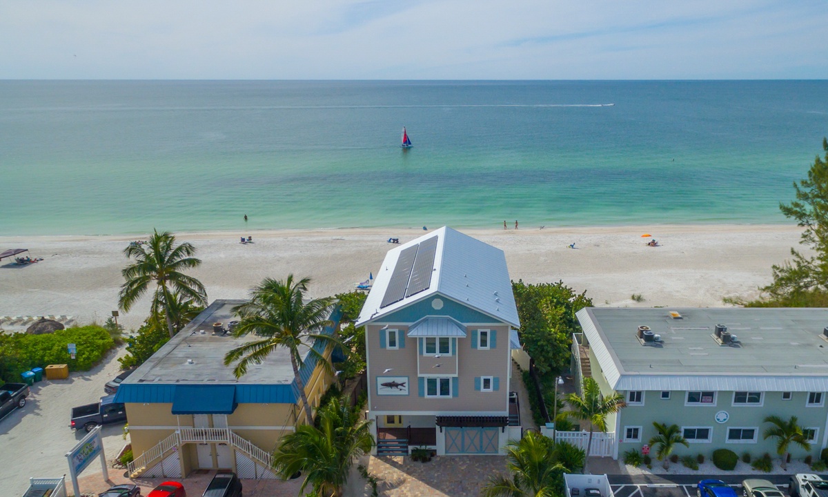 Arial shot of a beach in on Anna Maria Island with the ocean in the background.