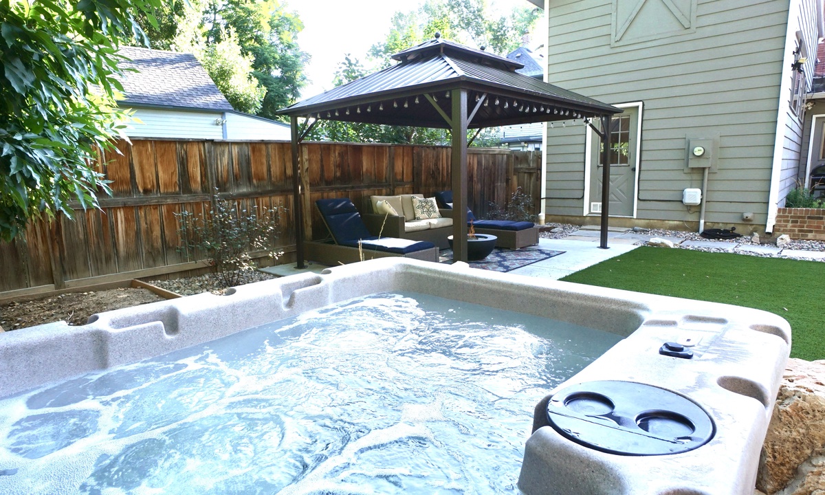 Backyard | Hot Tub, Shaded Lounge Area and Chiminea