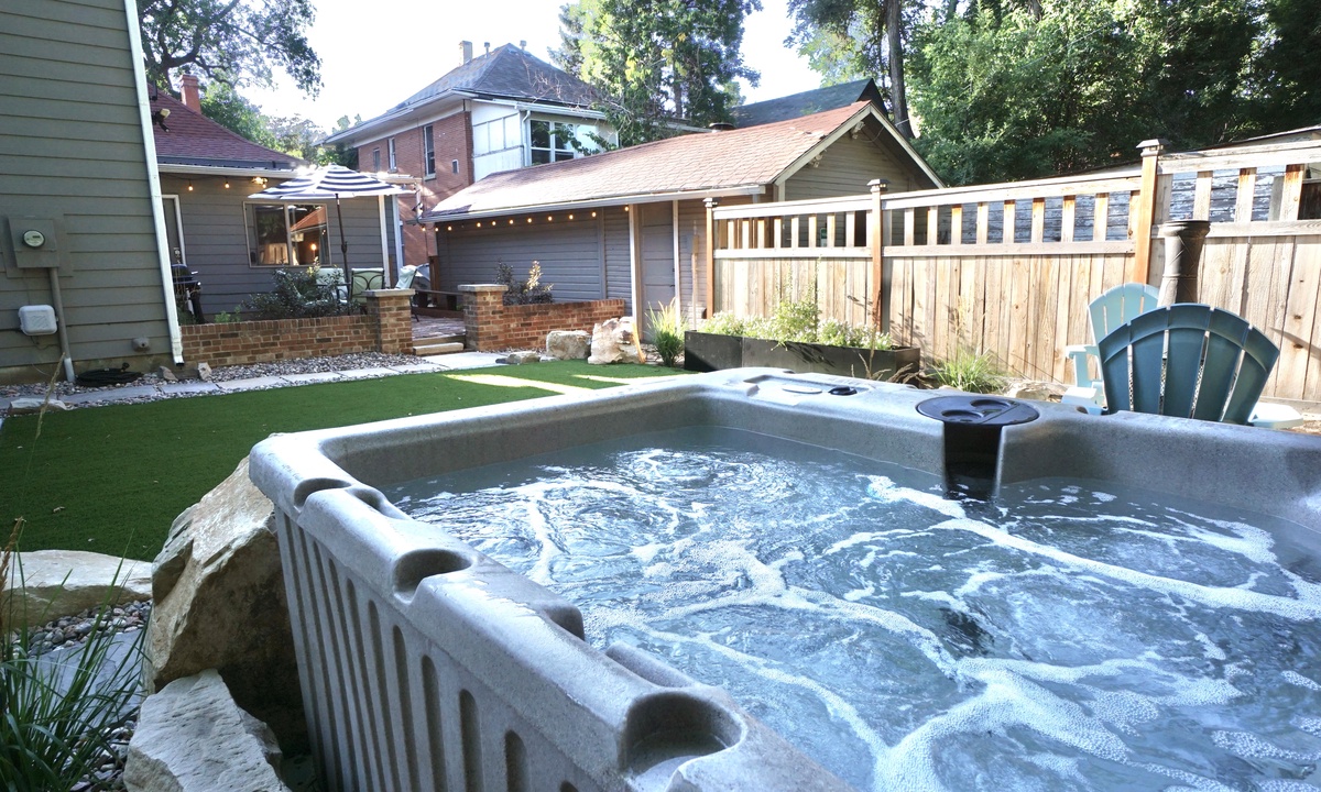 Backyard | Hot Tub, Shaded Lounge Area and Chiminea