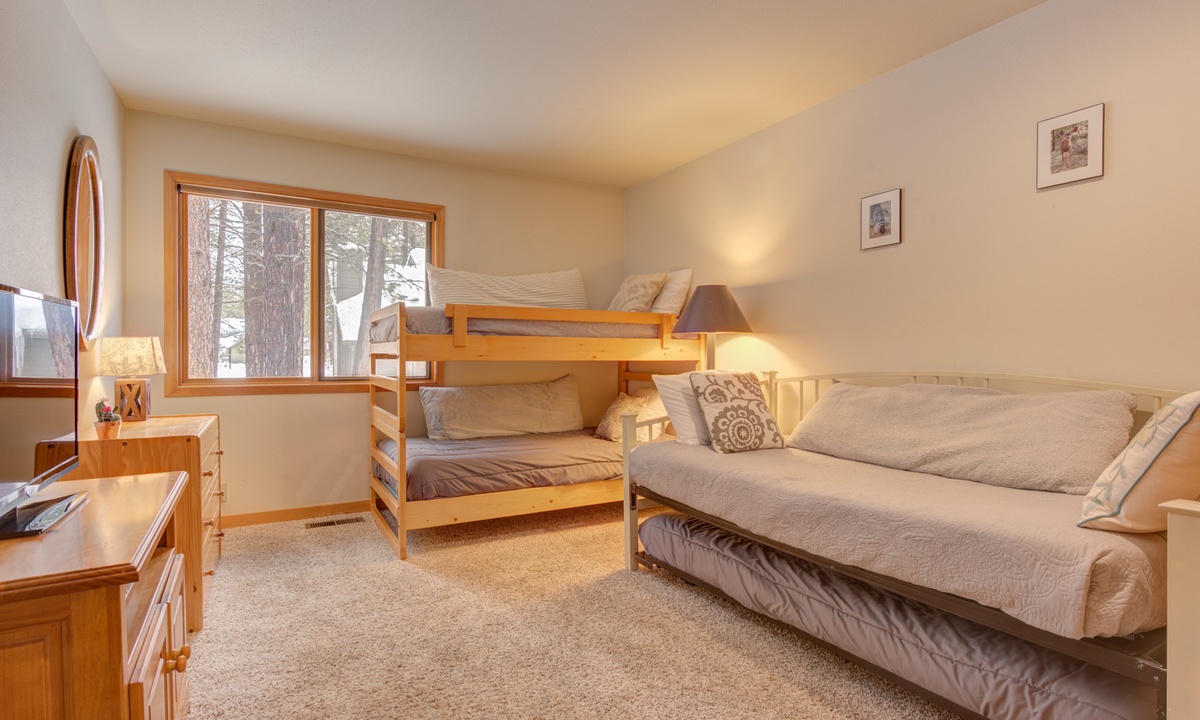 Guest bedroom with twin bed, trundle bed, and set of bunk beds