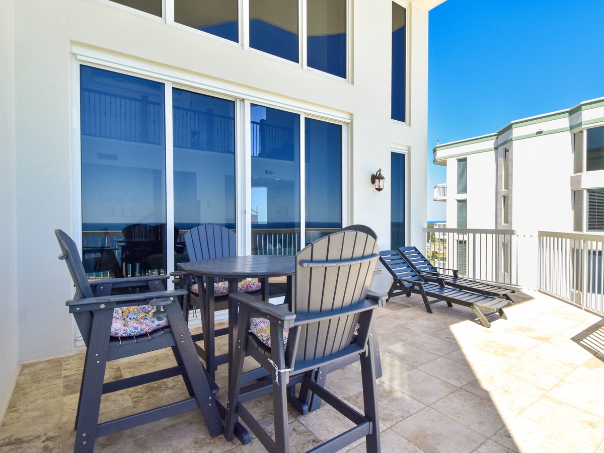 Your private balcony offers plenty of space to unwind, whether you're sipping morning coffee at the dining table or soaking up the sun on the lounge chair—all while taking in views of the surrounding area.