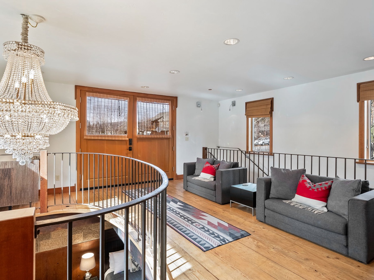 Unwind in your bright, airy living space with elegant chandeliers, plush sofas, and warm wood floors perfect for relaxing after a day of adventure.