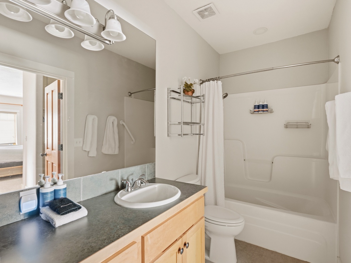 Your private bathroom features fresh towels, essential amenities, and a convenient shower-tub combo for relaxing after your adventures.