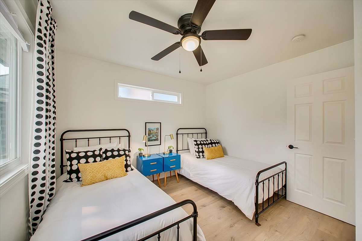 Two comfortable beds await in this cheerful room with polka dot accents and a ceiling fan to keep you cool.