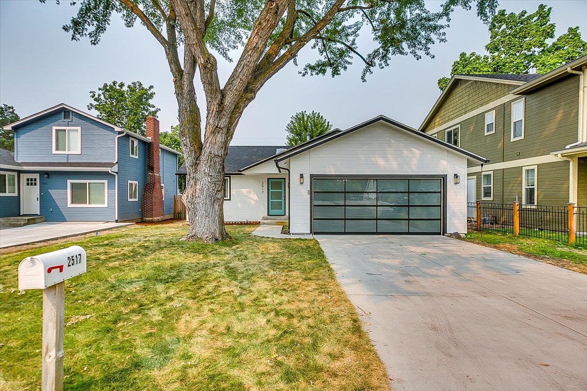 Modern vacation rental located in a charming residential neighborhood with convenient driveway parking and mature tree-lined streets.