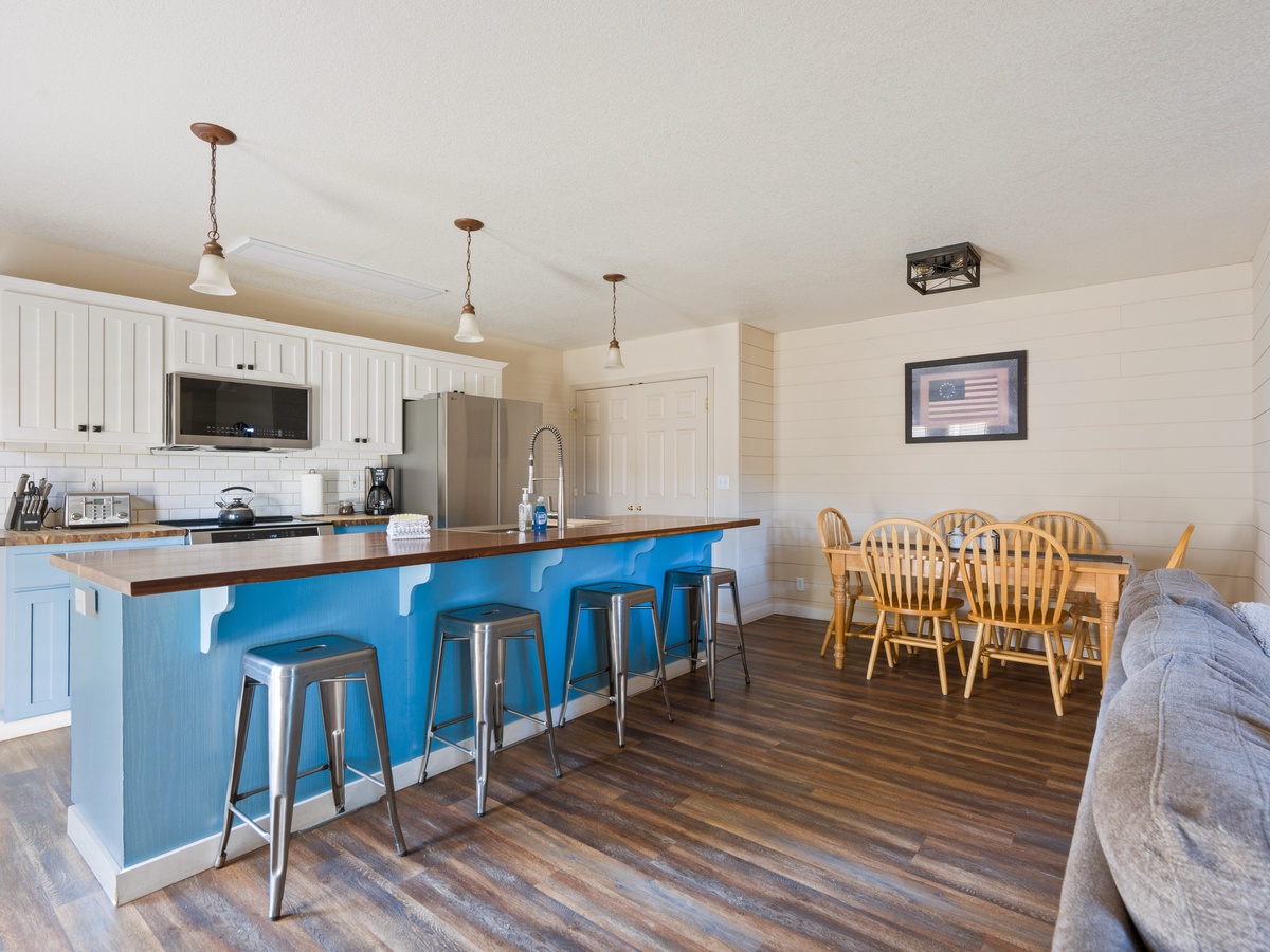 Your spacious open-concept kitchen features a charming blue island perfect for morning coffee and meal prep together.