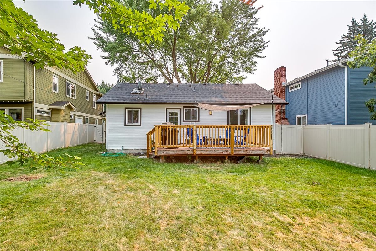 This charming property features a welcoming wooden deck overlooking a spacious private yard, nestled in a quiet residential neighborhood.
