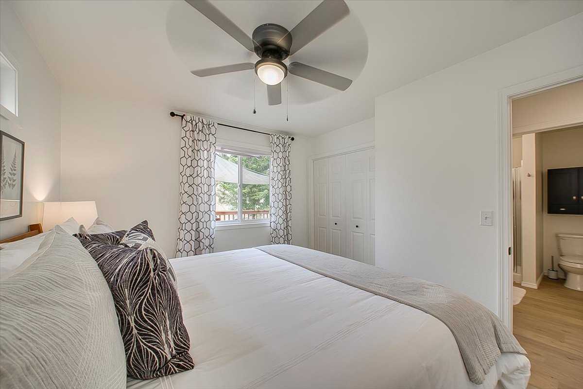 Rest peacefully in your bright, airy bedroom featuring a ceiling fan for comfort and plenty of natural light streaming through your window.