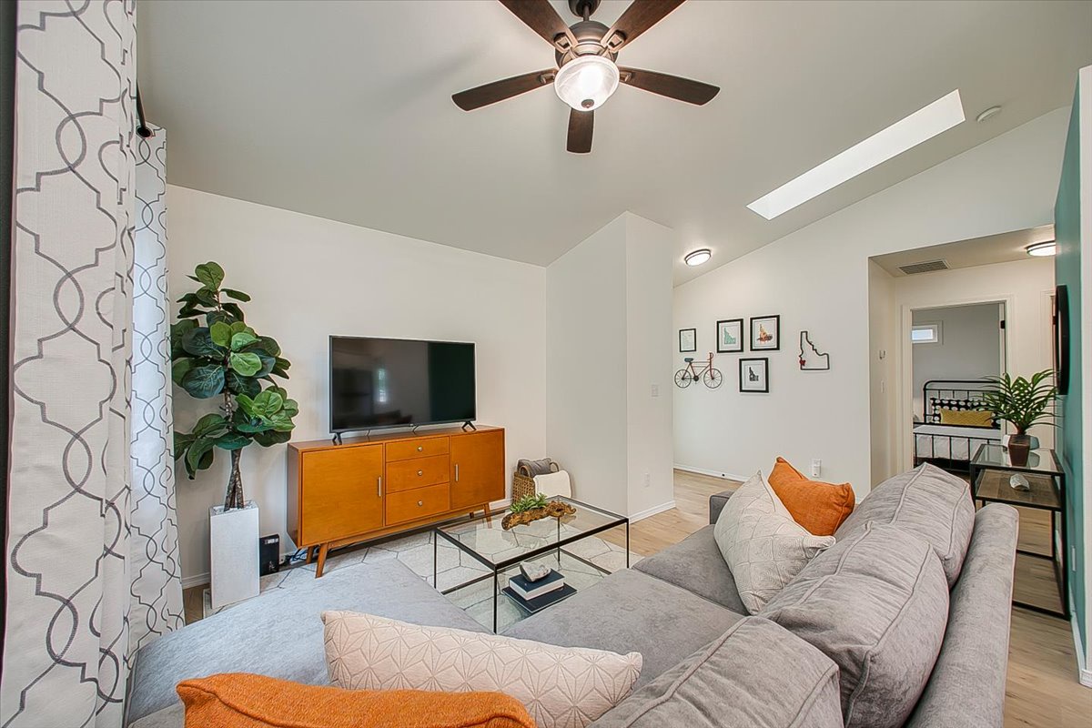 Sink into this stylish living room where modern comfort meets mid-century charm, complete with plush seating and thoughtful design touches for your perfect stay.