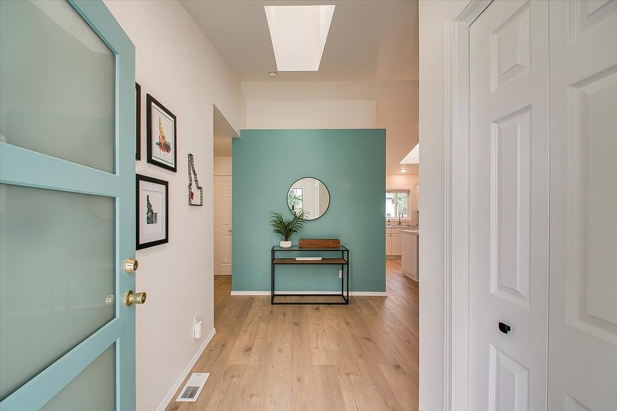 Step into your welcoming entryway with warm wood floors and soothing mint accents creating an instantly calming arrival experience.