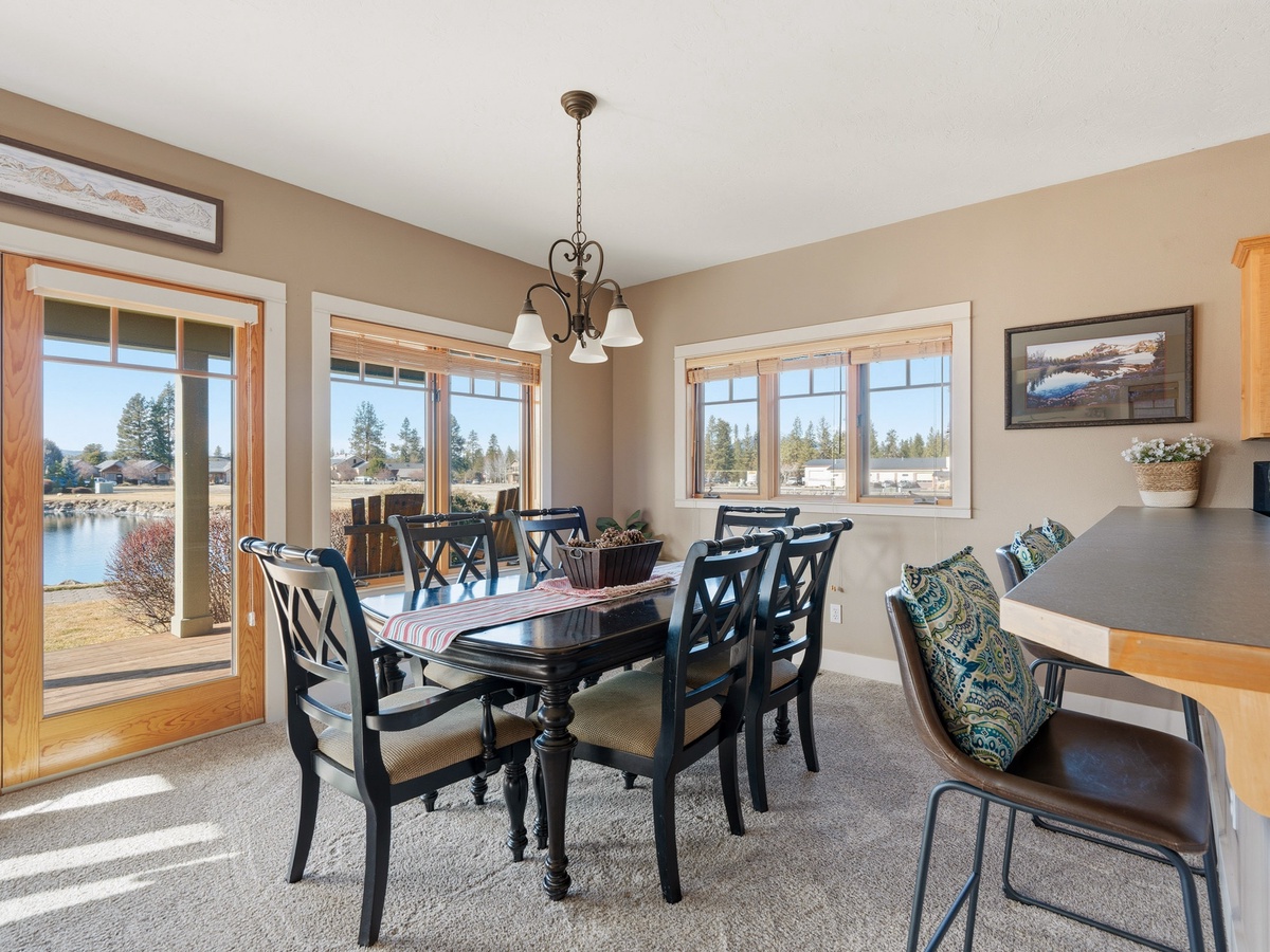 Gather around this elegant dining table where lakefront views create the perfect backdrop for your memorable meals together.