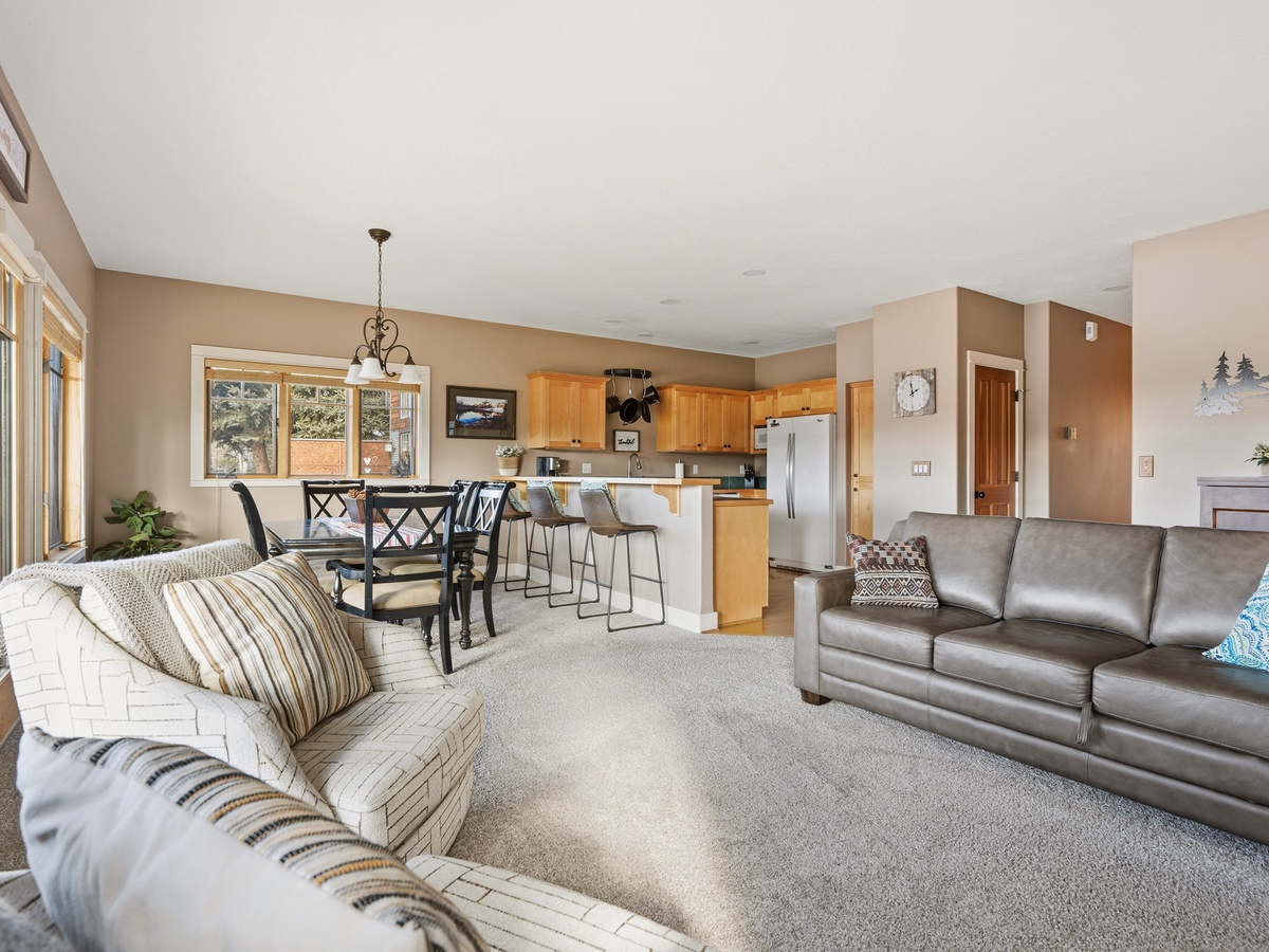 Relax in this spacious open-concept living area where comfortable sofas invite you to unwind after your mountain adventures.