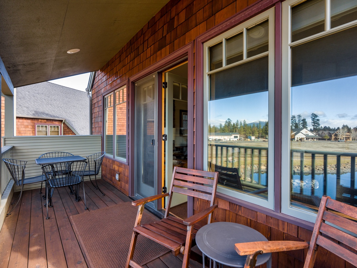 Relax on your private waterfront balcony with comfortable seating and stunning lake views stretching to distant mountains.