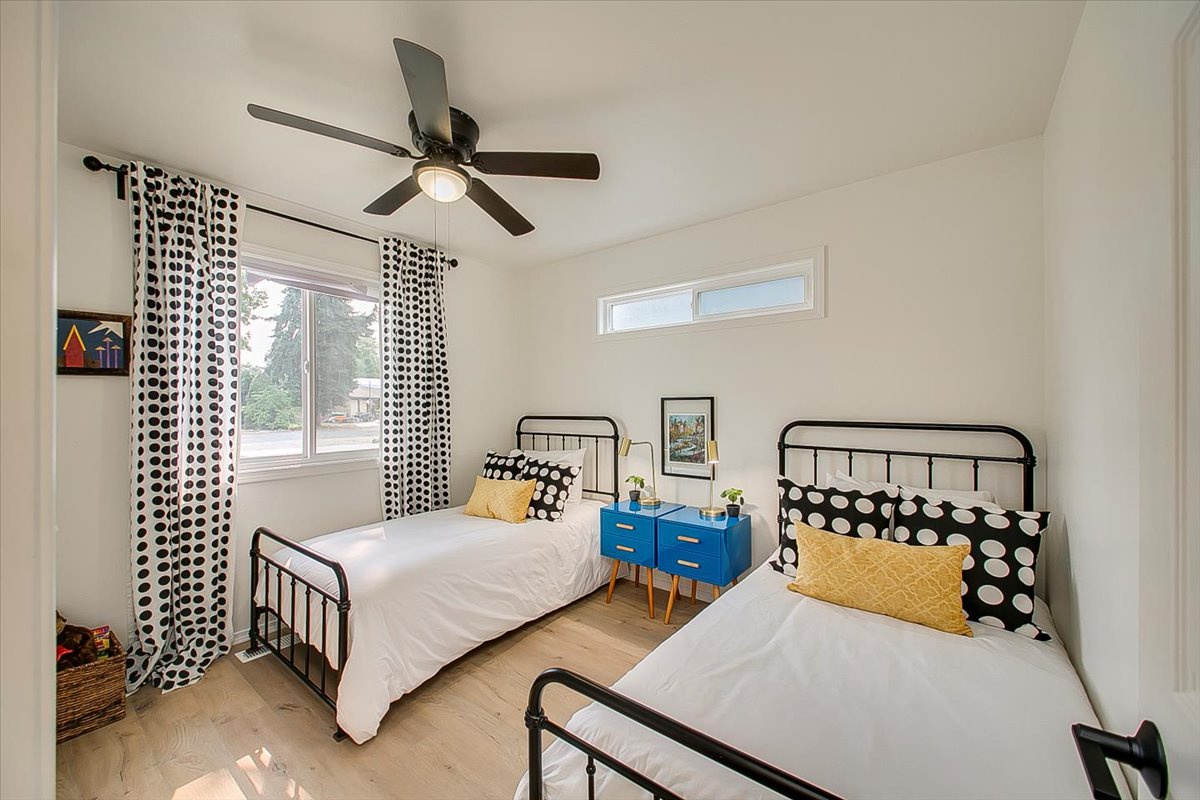 Your kids will love this cheerful twin bedroom with its playful polka dot decor and cool ceiling fan for comfortable sleep.