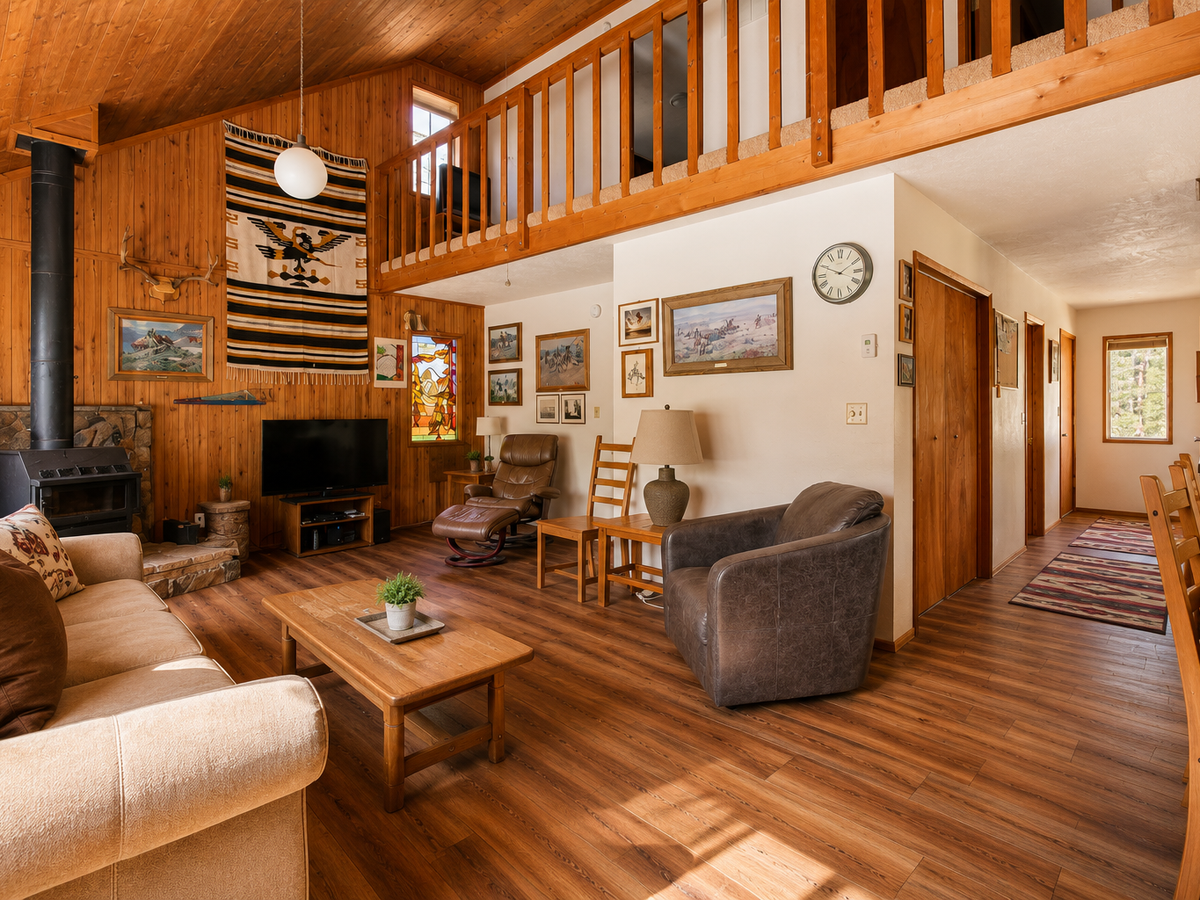 Unwind in your spacious living room with vaulted wood ceilings, cozy fireplace, and a loft—perfect for gathering after a day of adventure.