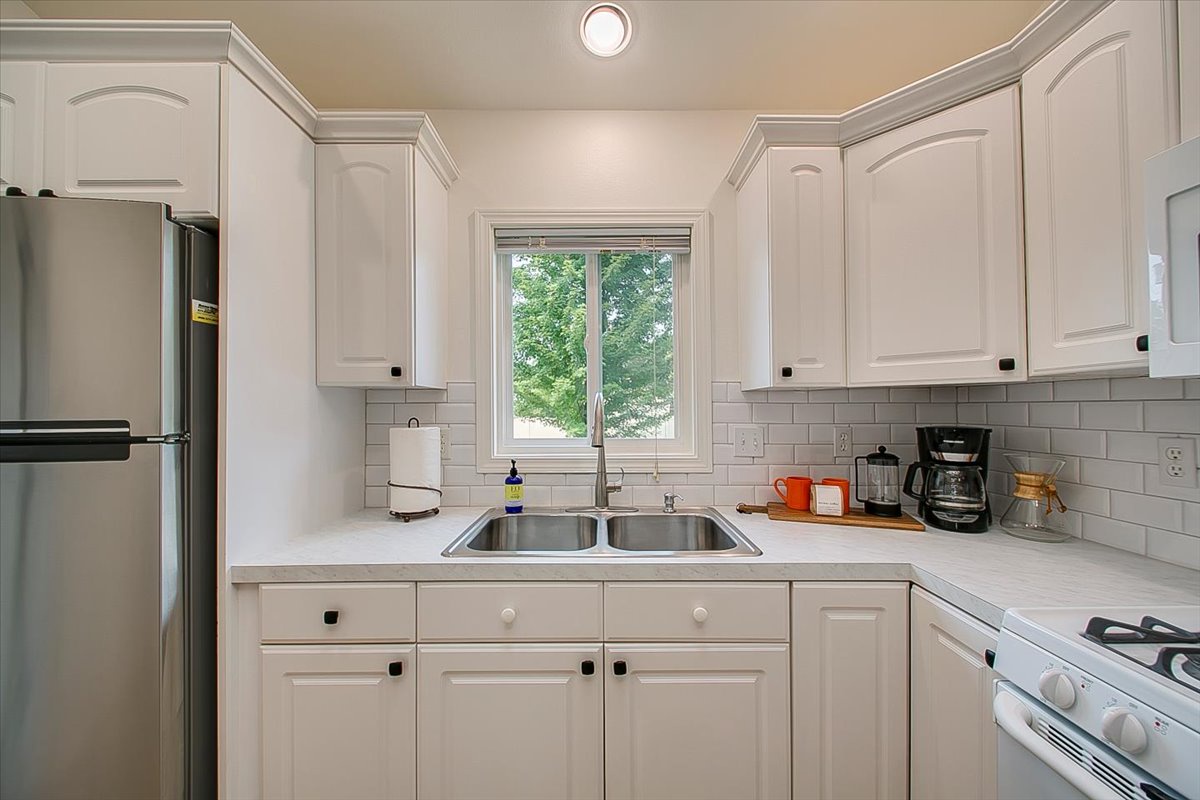 Cook your favorite meals in this bright, fully-equipped kitchen with modern appliances and garden views.