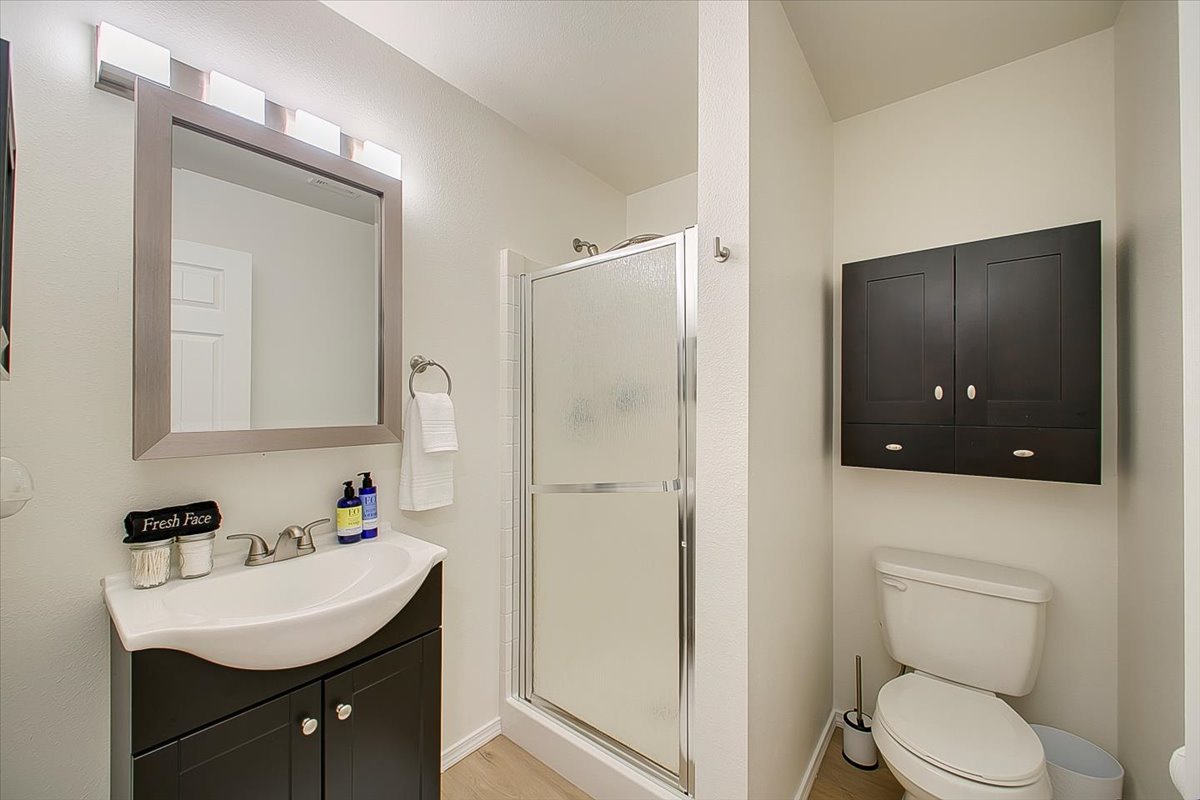 Your private bathroom features a spacious walk-in shower, modern vanity with ample storage, and thoughtfully placed lighting for your daily routine.