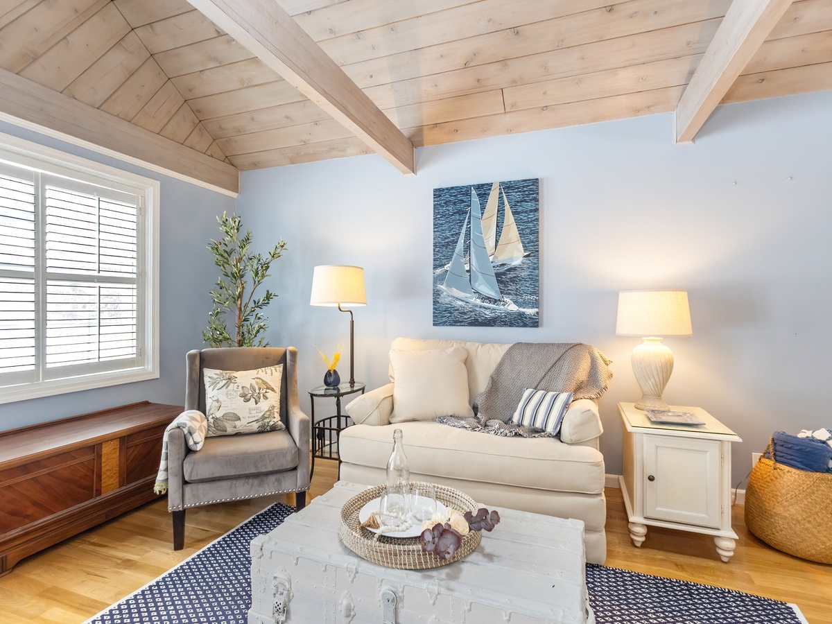 The serene living room invites you to unwind with a good book and a moment of quiet.