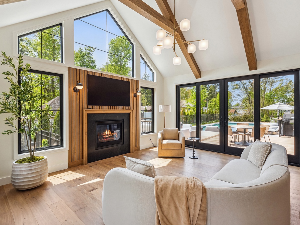 Designer living spaces with vaulted ceilings and pool views