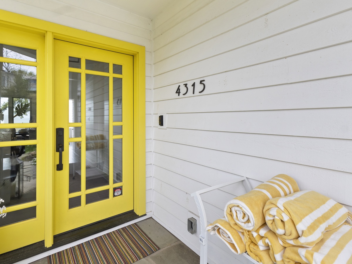 This yellow door welcomes you to make yourself at home