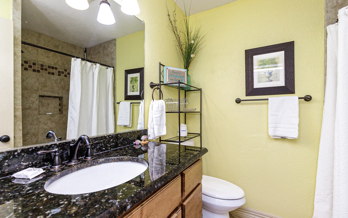 Your spacious bathroom features granite countertops, fresh towels, and a relaxing tiled shower—perfect for unwinding after your adventures.