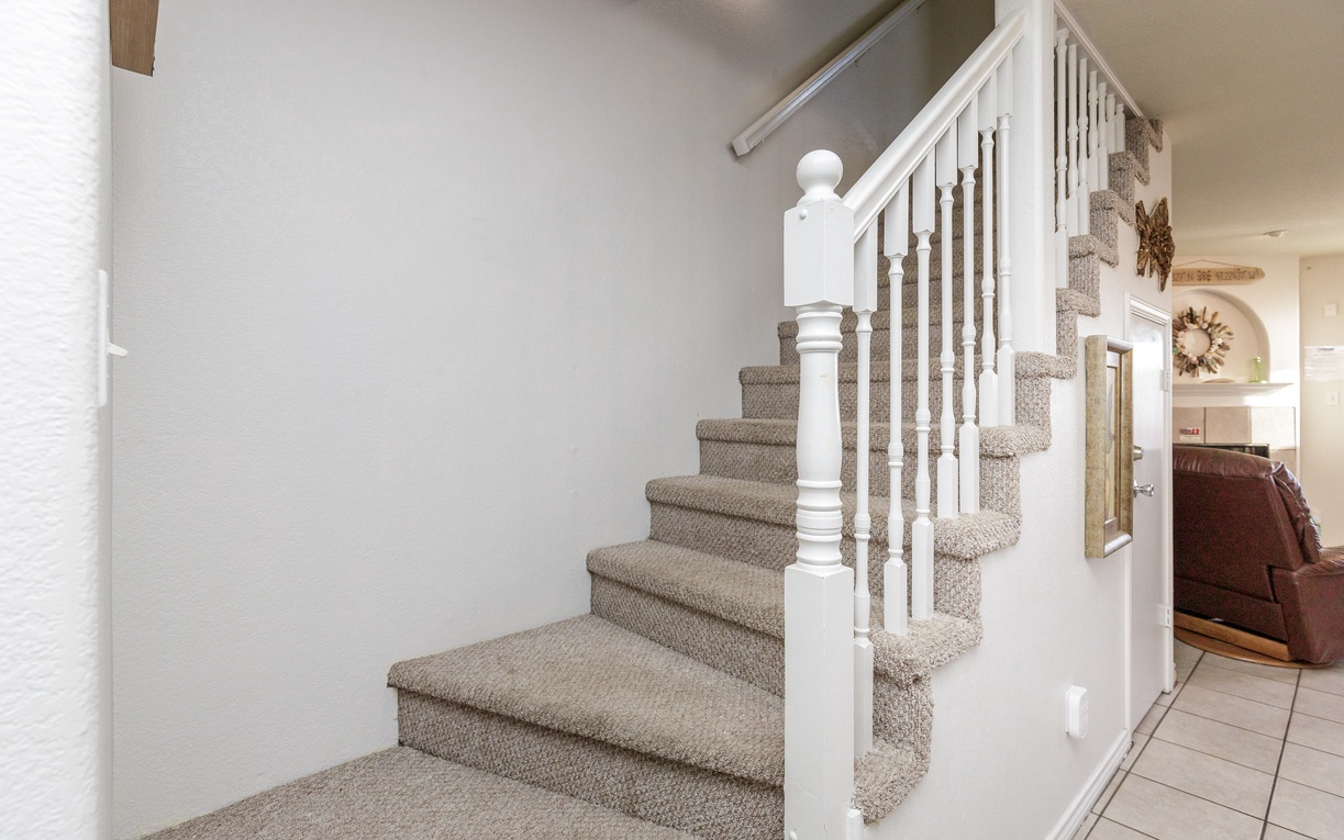 Ascend the carpeted staircase to your private upper level, where comfort meets coastal charm.