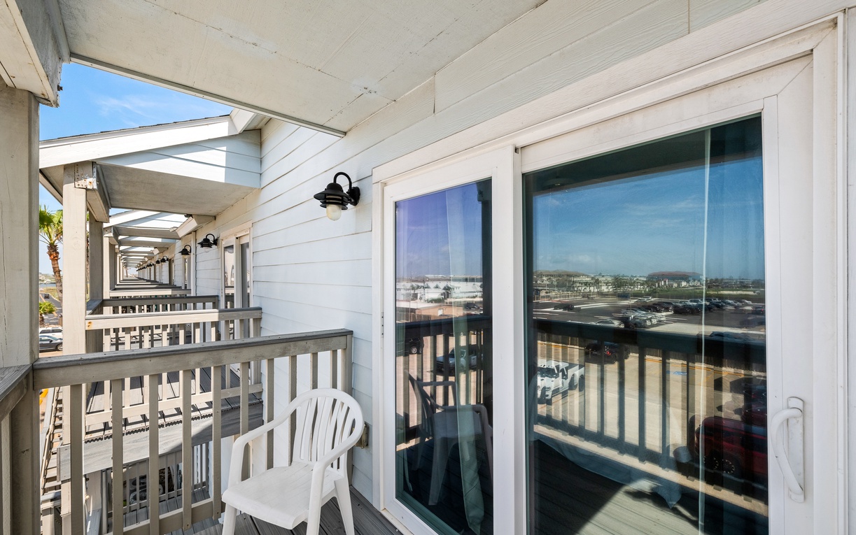 Step outside onto the private balcony, a peaceful spot to relax and enjoy the fresh coastal air and surrounding views.
