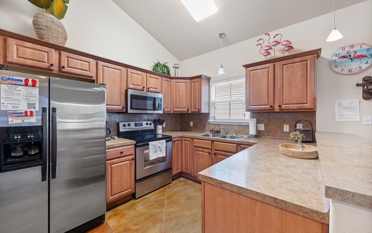 Your fully equipped kitchen invites you to create delicious meals with stainless steel appliances, granite countertops, and warm wood cabinetry.