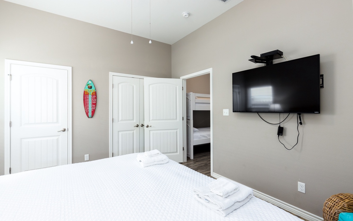 Relax in your peaceful bedroom with modern comforts, including a wall-mounted TV and convenient closet storage for all your belongings.