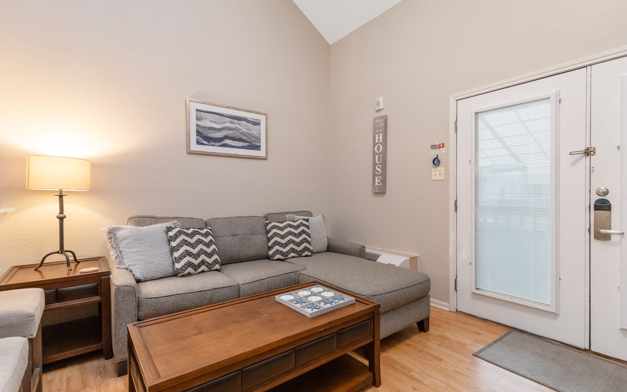 Unwind in your cozy living room with a plush sectional sofa and warm lighting that creates the perfect atmosphere for relaxation.