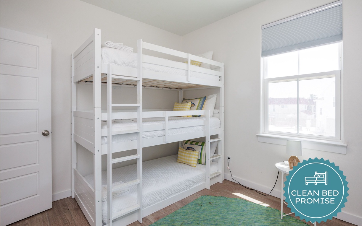 Drift off in this bright bunk room where natural light streams through your window, creating the perfect space for restful sleep.