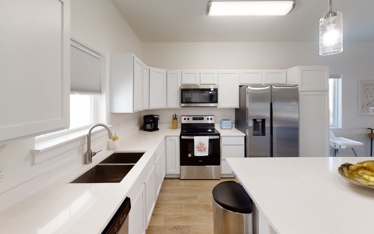 Your bright, fully-equipped kitchen invites culinary adventures with stainless steel appliances, generous counter space, and everything needed for memorable meals.