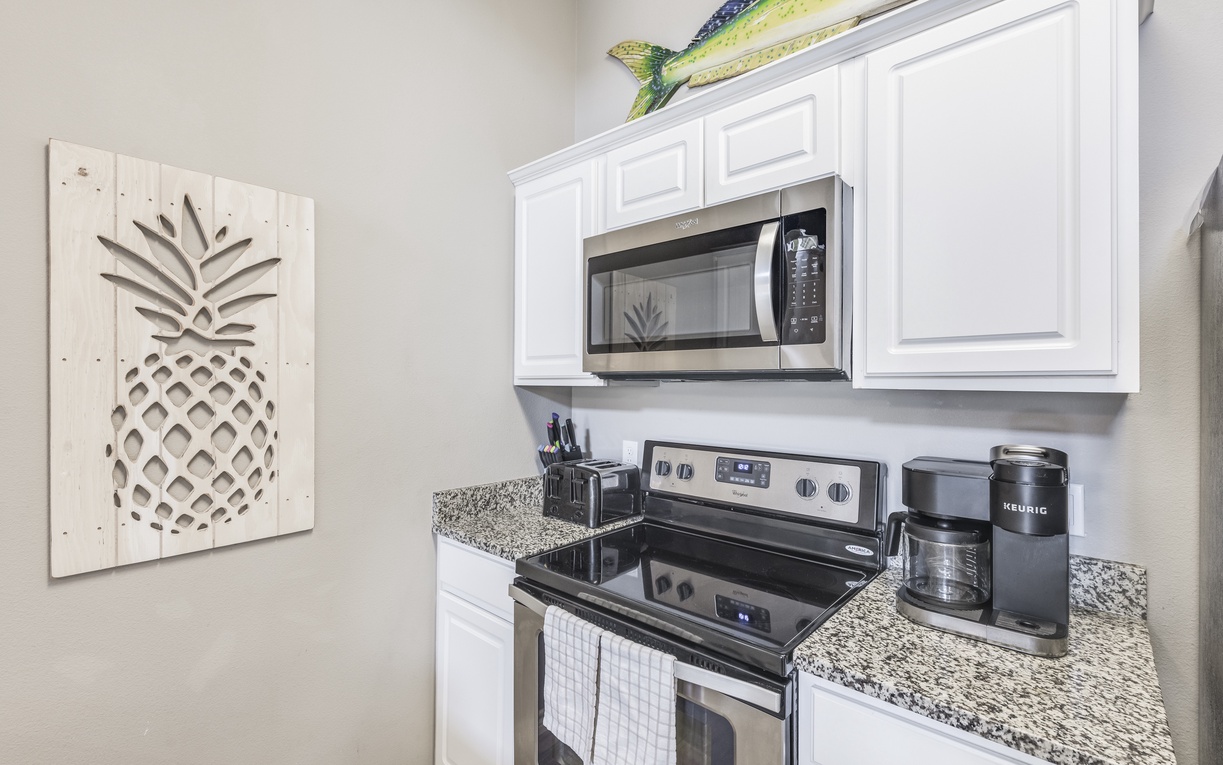 Your fully equipped kitchen features granite countertops, stainless steel appliances, and cheerful pineapple décor to make cooking feel like a tropical getaway.