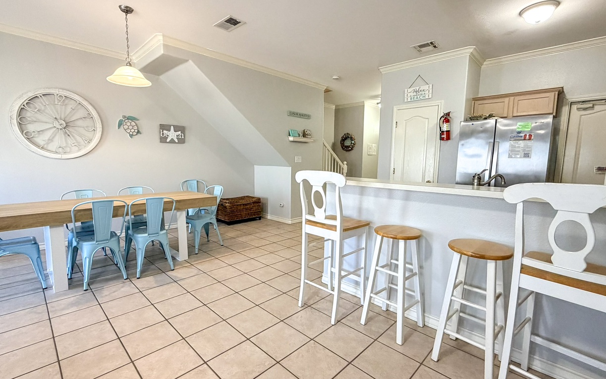 Gather around your bright kitchen island or dining table with coastal charm and turquoise chairs welcoming memorable meals together.